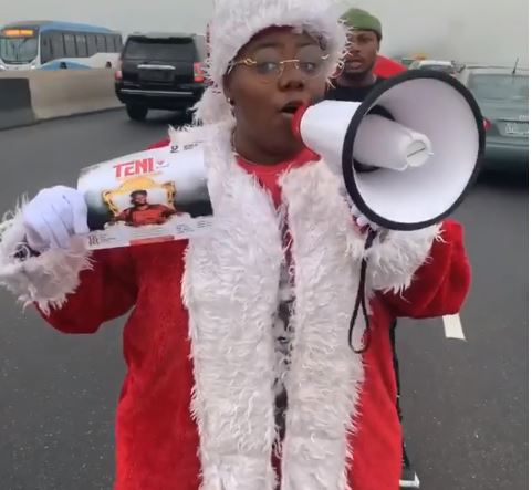 Teni dressed as Santa Claus