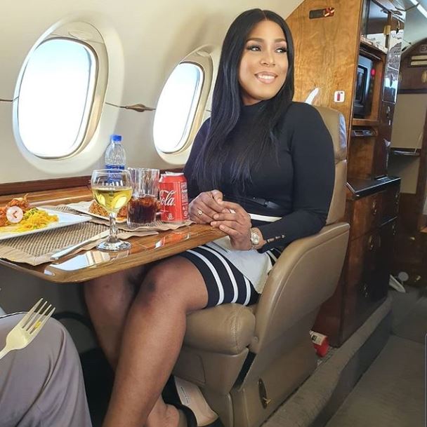 Linda Ikeji and father posing inside a private jet