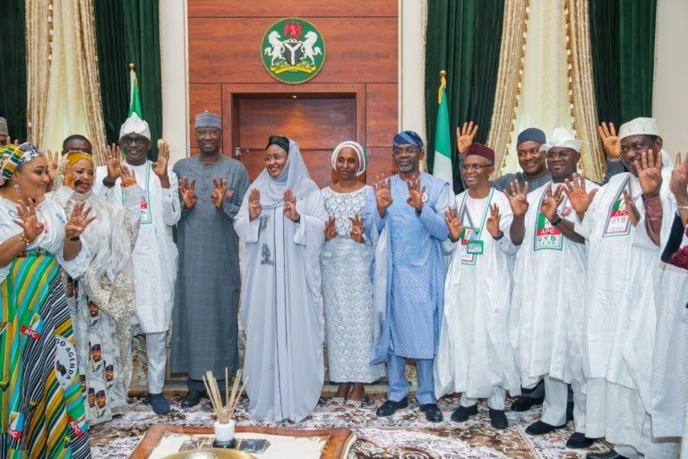 APC members showing off four+four sign