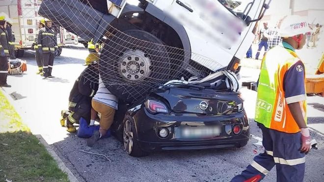 Woman survives with injuries after heavy lorry landed on her car