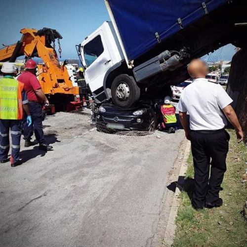 Woman survives with injuries after heavy lorry landed on her car