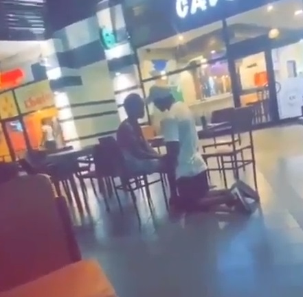 The man kneeling to beg his girlfriend