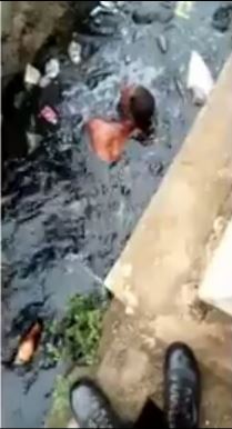 Man swimming in dirty water