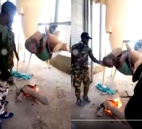 Soldiers seen hanging suspect above fire to 'roast'