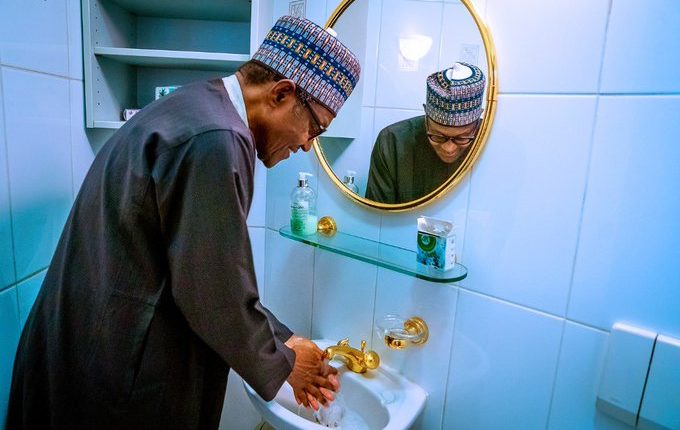 Buhari washing hands with gold-plated tap