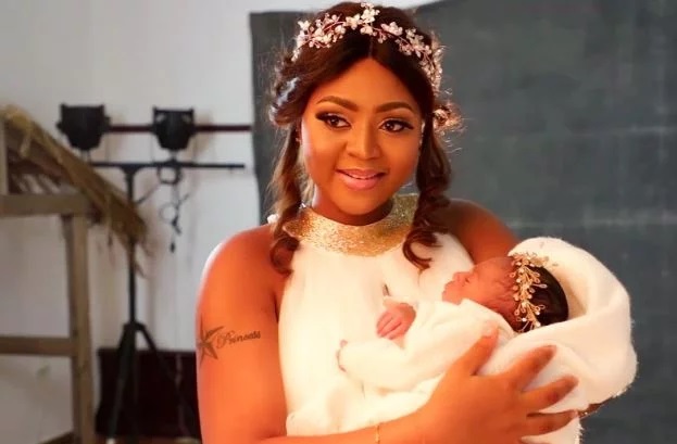 Regina Daniels shows off the face of her newborn baby