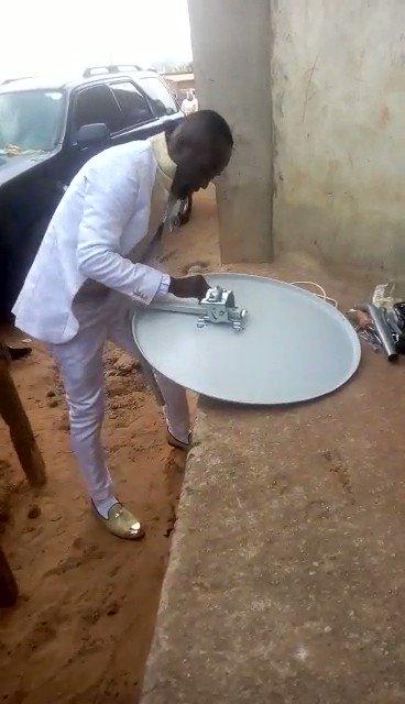 The groom fixing Dstv for a customer on his wedding day  