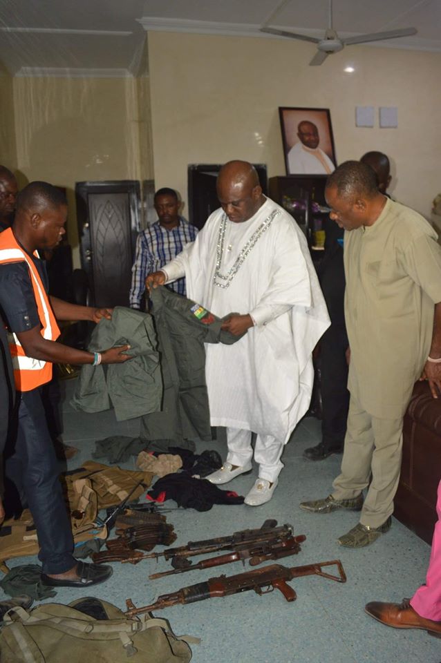 OPM founder, Apostle Chibuzor Gift Chinyere shows off the weapons recovered by the church from notorious armed roober
