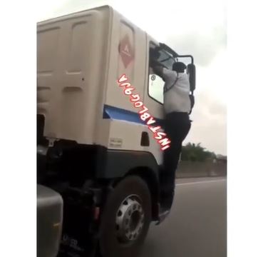 Vehicle Inspection officer clinging to a speeding truck