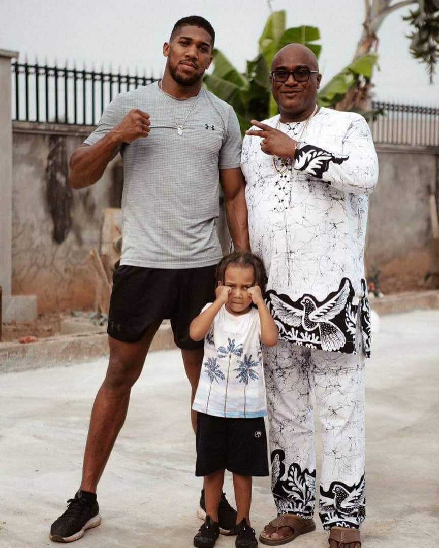 Anthony Joshua alongside his father and son