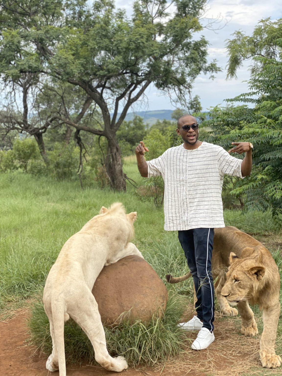 Omashola Kola Oburoh posing with lions