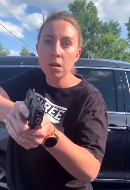 The white woman pulled a gun at the black woman during an argument.