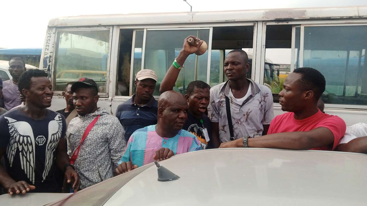 A car owner (right) looks at a smiling bidder (left) yesterday