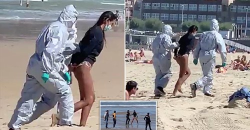 The woman dragged off the beach by officials
