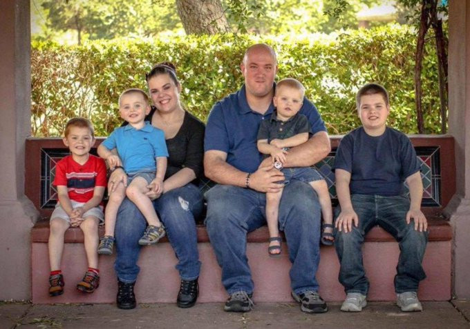 Freedy carrying their child while posing with fiancee and their kids