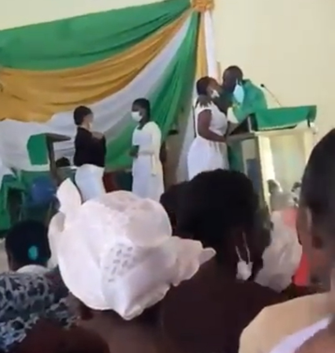 The priest kissing female students
