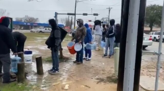 Texas residents lineup to fetch water from a borehole