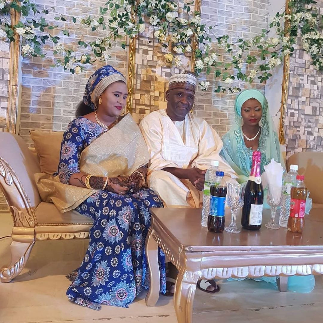 First wife posing with husband and his new wife