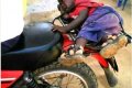 Disturbing Photo Of A Crying Kid Tied To A Motorcycle Surfaces