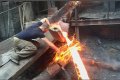 Unbelievable: Man Seen Putting His Hand Into A Burning Molten Metal Without Being Hurt (Video) 