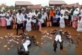 Drama As Pastor Rolls In Engine Oil While Members Spray Money On Him During Crusade (Video) 
