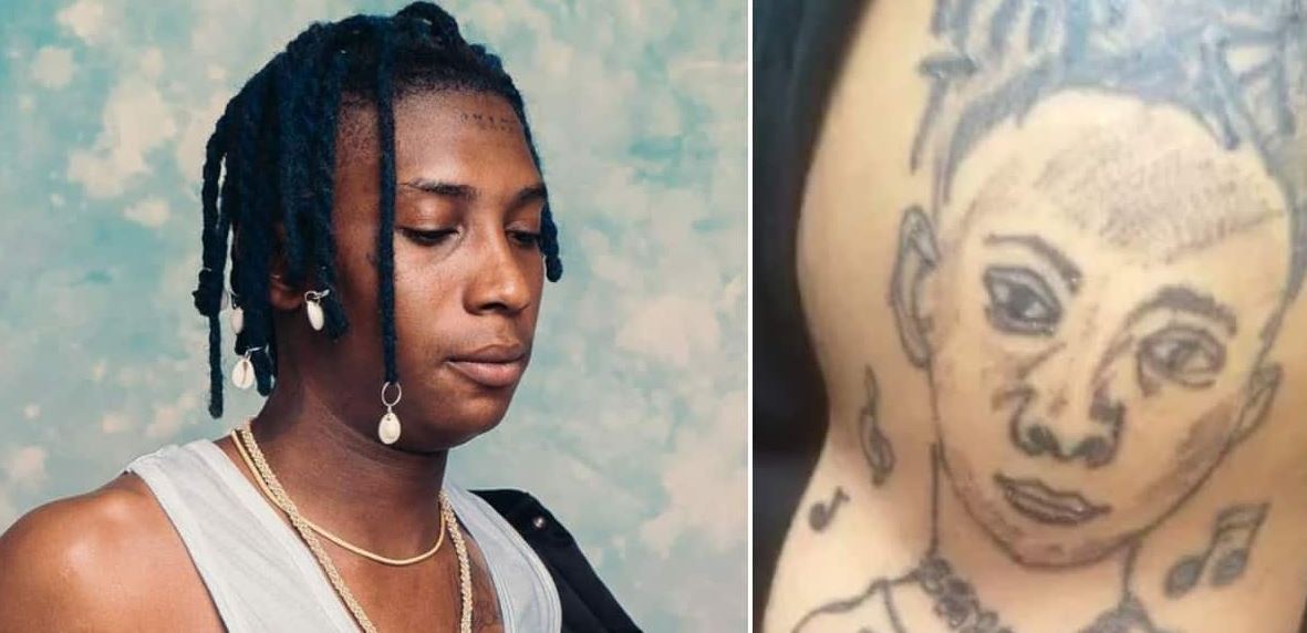 ''It Looks Like A Masquerade'' - Nigerians React As Fan Tattoos Bella Shmurda’s Face On His Arm