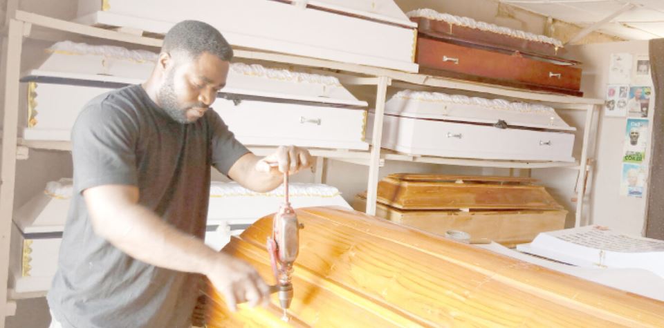 Meet Olushoto, The Nigerian Computer Graduate Who Turned Into A Coffin Maker